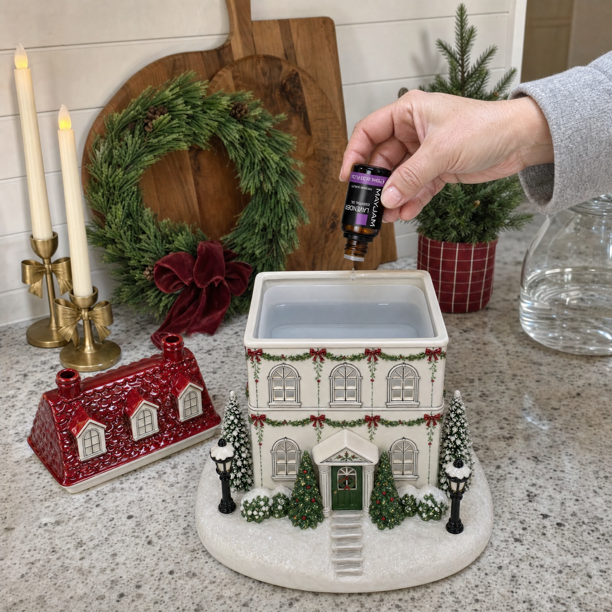 Adding essential oil to the Christmas house diffuser water tank